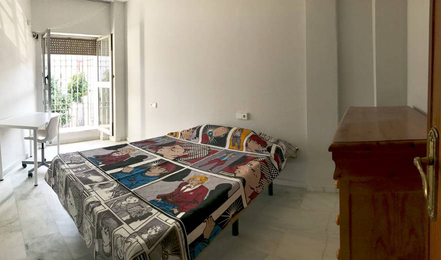 Central room with large window and balcony .
